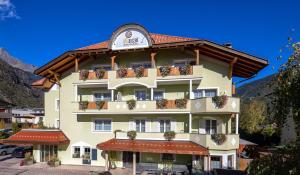 a large building with balconies and plants on it at Wohlfühlhotel Mei Auszeit in Plaus