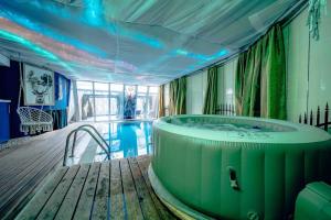 a hot tub in a room with a pool at Unique apartment with private pool, cinema, SPA in Prague