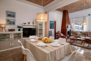 a kitchen and living room with a table and chairs at San Luis in Jávea