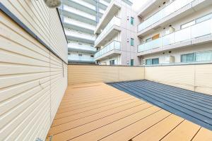 a building with a wooden floor in front of a building at 星野の宿 日本橋黒門道頓堀心斎橋難波エリア中心地 in Osaka