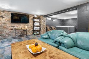 a living room with a couch and a plate of fruit at Willa pod Warszawą & SPA & Grota Solna in Rybie