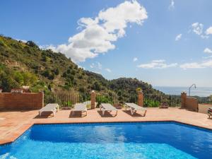 a swimming pool with a view of a mountain at Cubo's Villa La Gitanilla in Mijas