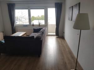 a living room with a couch and a large window at Gemütliche Wohnung "Charly" zum Wohlfühlen zu allem gut angebunden in Paderborn