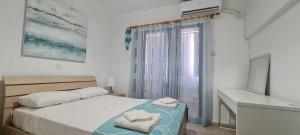 a bedroom with a bed with two towels on it at STAY EasyDream Maisonette in Paralimni