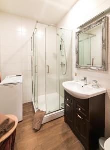 a bathroom with a sink and a shower at Cottage Dzintars in Jūrmala +3 photos