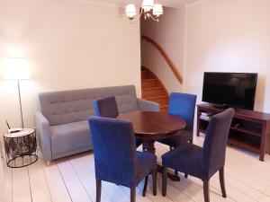 a living room with a table and chairs and a couch at Cottage Dzintars in Jūrmala
