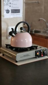 a tea kettle sitting on top of a stove at Profcon Resort in Graaff-Reinet