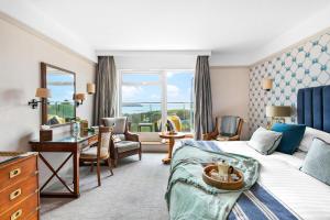 a hotel room with a bed and a desk at Thurlestone Hotel in Thurlestone