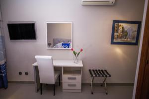 a white desk with a white chair and a mirror at Hotel Bajamar Centro in Nerja