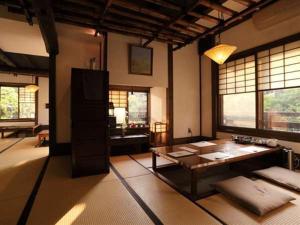 a living room with a table and some windows at Fujiya in Minamioguni