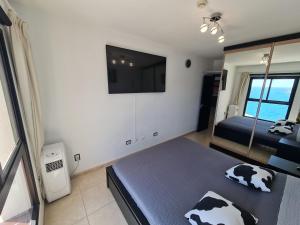 a bedroom with a bed with cow pillows on it at DELUXE 3 Rooms74m2,TRANSFE-R inc! SEAVIEW on AMADORES,2 heatPOOLs, PARKING, 600 MB,Dishwasher,2Lift,,3 BEACHes in Playa del Cura