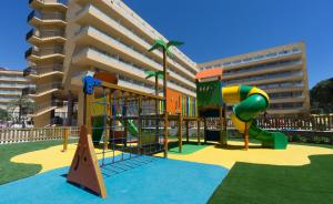 a playground in front of a apartment building at Medplaya Hotel Calypso in Salou