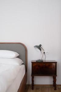 a lamp on a nightstand next to a bed at 1477 Reichhalter in Lana