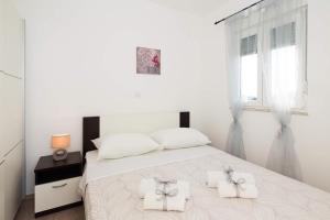 Postel nebo postele na pokoji v ubytování Apartments Sucic