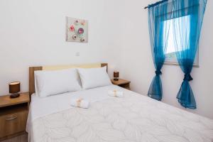 Postel nebo postele na pokoji v ubytování Apartments Sucic