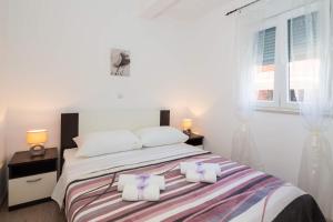 Postel nebo postele na pokoji v ubytování Apartments Sucic