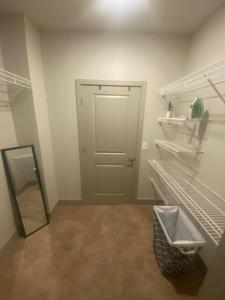 a room with a door and a shelf and a mirror at Luxurious 1 BR Apt in Ybor City in Tampa