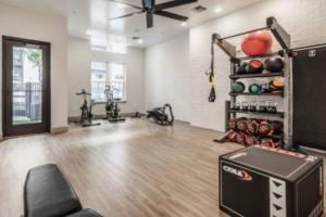 a room with a gym with bikes and a fan at Luxurious 1 BR Apt in Ybor City in Tampa