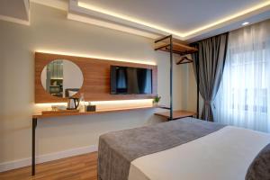 a hotel room with a bed and a mirror at Depiero Hotel Karaköy in Istanbul