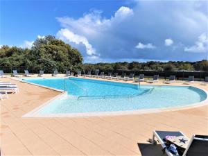 een groot zwembad met ligstoelen op een resort bij L Escale - 6 personnes in Saint-Hilaire-de-Talmont