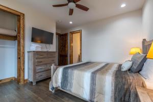 a bedroom with a bed and a flat screen tv at Clouds Rest at Eagles Nest in Beech Mountain