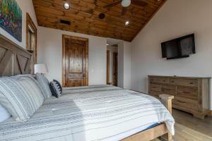 a bedroom with a large bed and a television at Clouds Rest at Eagles Nest in Beech Mountain