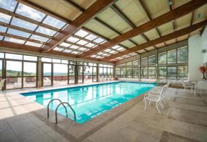 a large swimming pool with a large ceiling at Flat 305 - Gramado in Gramado