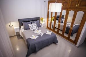 a bedroom with a bed with two white flowers on it at Hotel Bajamar Centro in Nerja