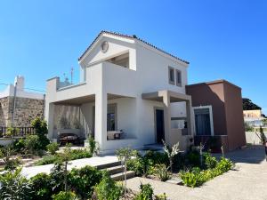 a white house with a lot of plants at Easy Living 1 & 2 in Kos Town