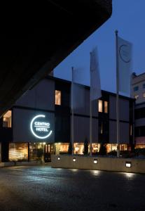 a building with a sign on the side of it at night at Centro Hotel Turku in Turku
