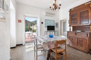 a dining room with a table and a television at Rezzano 12 in Bonassola