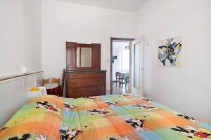 a bedroom with a bed with a colorful comforter at Rezzano 12 in Bonassola