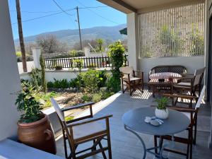 a patio with tables and chairs and a view at Easy Living 1 & 2 in Kos Town