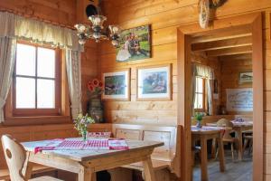 a dining room in a log cabin with a wooden table at Bio Schartenalm in Mühlbach am Hochkönig