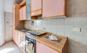 una piccola cucina con piano di lavoro e piano cottura di Casetta Orchidea A pochi passi dal Centro a Lampedusa