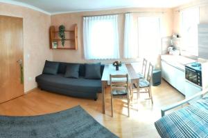 a living room with a blue couch and a table at zentrale & ruhige Ferienwohnung in Mössingen +27 photos