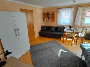 a living room with a couch and a table at zentrale & ruhige Ferienwohnung in Mössingen
