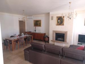 a living room with a couch and a table and a fireplace at CASAVACANZE MEVANIA in Bevagna