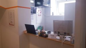 a kitchen with a counter with a laptop on it at Al-Xelb guesthouse in Silves