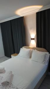 a bed with white sheets and pillows in a bedroom at Ali's Pension in Egirdir