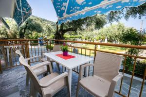 a white table and chairs on a balcony at Holiday Villa Thassos in Koinyra