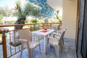 a white table and chairs on a balcony at Holiday Villa Thassos in Koinyra