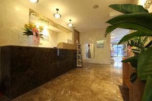 釜山Hotel Prima Busan的大堂,有柜台,商店里种植了植物