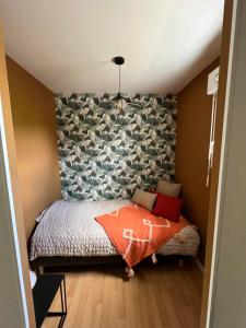 a small bedroom with a bed in a room at Ty kalon in Carantec +5 photos