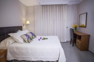 a hotel room with a bed with flowers on it at Hotel Bajamar Centro in Nerja