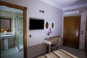 a bathroom with a bed and a sink and a mirror at Hotel Bajamar Centro in Nerja