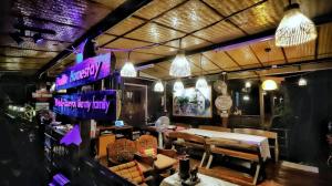 a restaurant with a table and chairs and lights at PunNa Homestay @ Bangsai in Ban Bang Sai