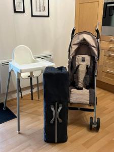 a baby cart with a backpack next to a desk at Ty kalon in Carantec