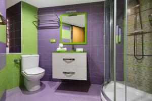 a purple bathroom with a toilet and a shower at Levante Sunset Front line apartment Almadraba in Benidorm +7 photos