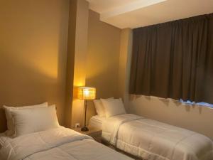 A bed or beds in a room at Athens Gem